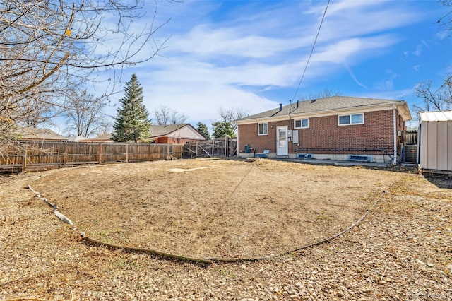 back of property with cooling unit, brick siding, and a fenced backyard