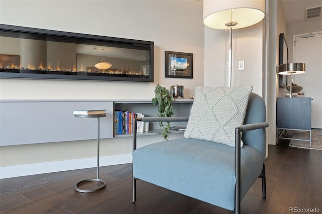 sitting room featuring dark wood-type flooring