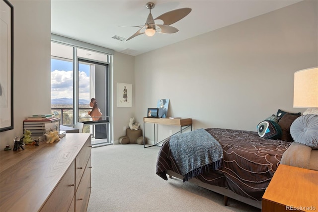 carpeted bedroom with ceiling fan and floor to ceiling windows