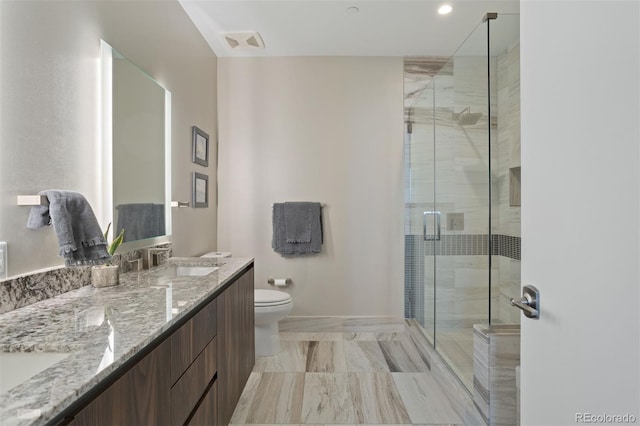 bathroom featuring vanity, an enclosed shower, and toilet