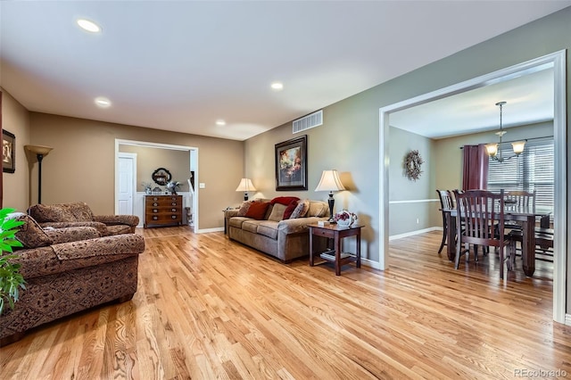 living room with recessed lighting, baseboards, visible vents, and light wood finished floors