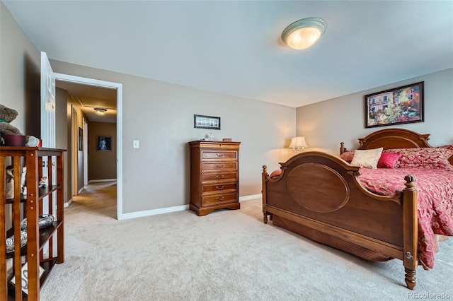 bedroom featuring baseboards and carpet