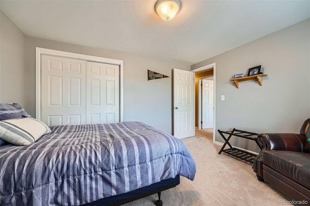 bedroom with a closet and light carpet