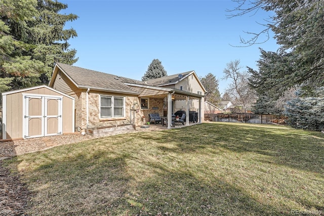 view of side of property featuring an outbuilding, fence, a shed, a yard, and a patio area