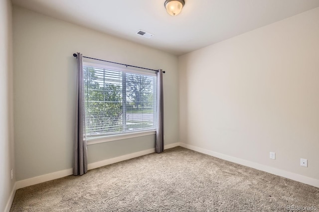 unfurnished room featuring carpet floors and baseboards