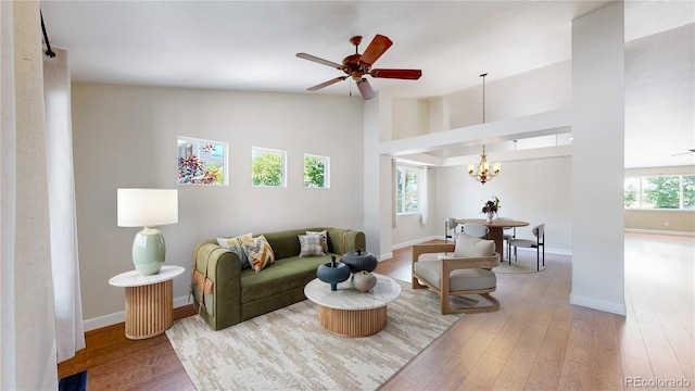 1936 E 144th Dr, Thornton, CO 80602 - living area with wood finished floors, a chandelier, a ceiling fan, and high vaulted ceiling