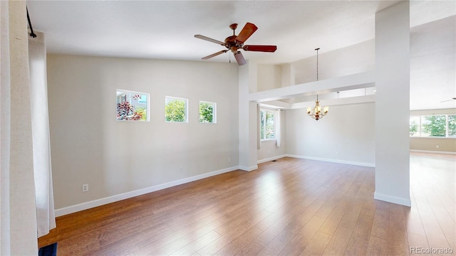 1936 E 144th Dr, Thornton, CO 80602 - spare room featuring a chandelier, ceiling fan, wood finished floors, and high vaulted ceiling