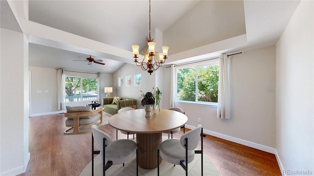 1936 E 144th Dr, Thornton, CO 80602 - dining room with vaulted ceiling, wood finished floors, a chandelier, and a ceiling fan