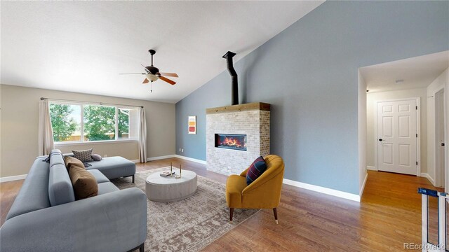 1936 E 144th Dr, Thornton, CO 80602 - living area featuring wood finished floors, ceiling fan, a fireplace, and high vaulted ceiling