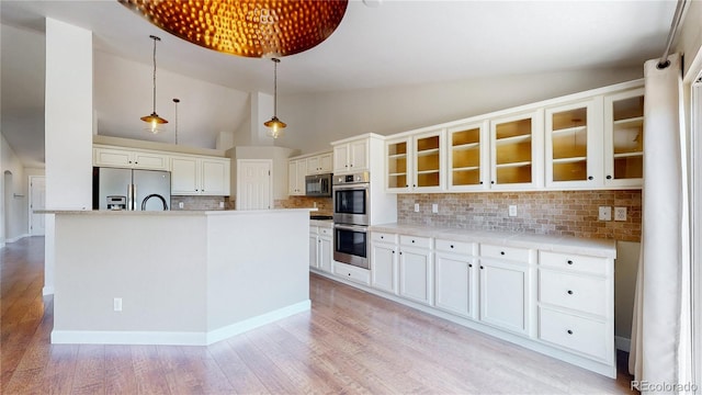 1936 E 144th Dr, Thornton, CO 80602 - kitchen featuring stainless steel appliances, lofted ceiling, light wood-style floors, backsplash, and glass insert cabinets