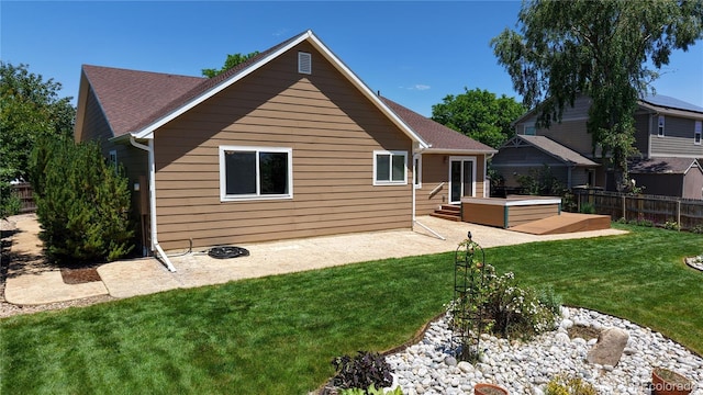 1936 E 144th Dr, Thornton, CO 80602 - rear view of house with a hot tub, a patio, and a shingled roof