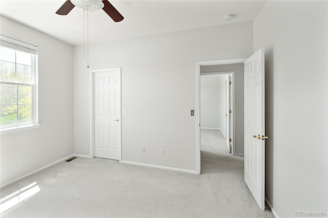 10511 Jaguar Gln, Lone Tree, CO 80124 - unfurnished bedroom featuring light carpet, baseboards, and ceiling fan