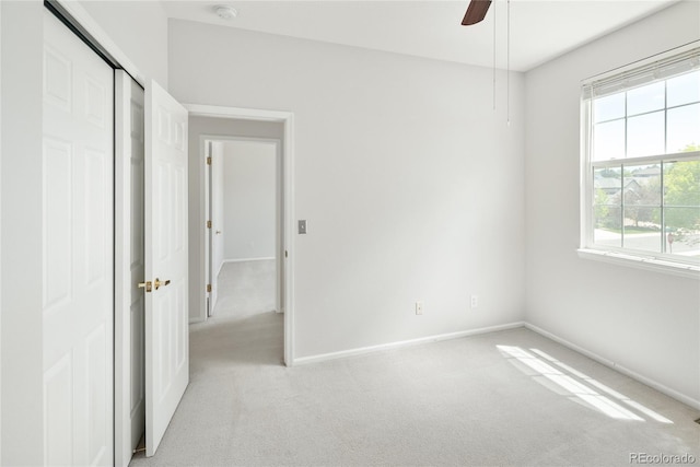10511 Jaguar Gln, Lone Tree, CO 80124 - unfurnished bedroom with light carpet, baseboards, ceiling fan, and a closet