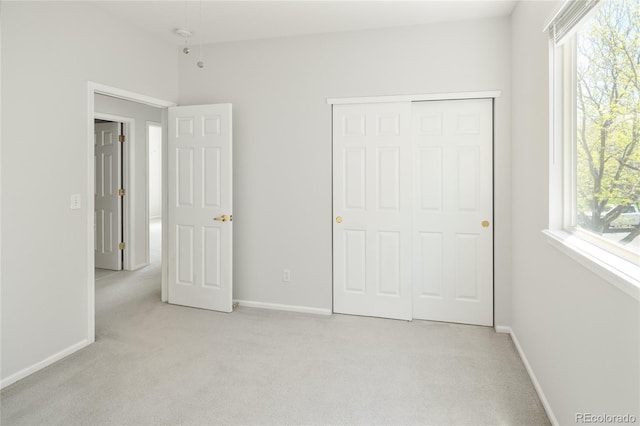 10511 Jaguar Gln, Lone Tree, CO 80124 - unfurnished bedroom featuring light carpet, baseboards, and a closet