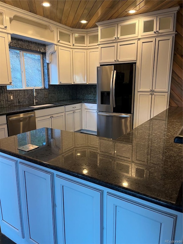 kitchen with white cabinets, wooden ceiling, and appliances with stainless steel finishes