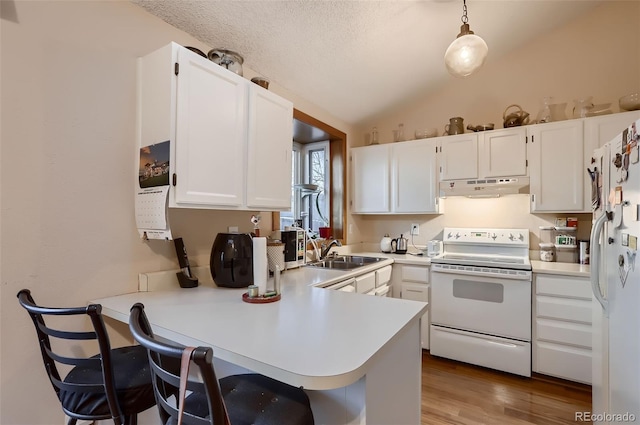 kitchen with kitchen peninsula, white appliances, sink, white cabinetry, and hanging light fixtures