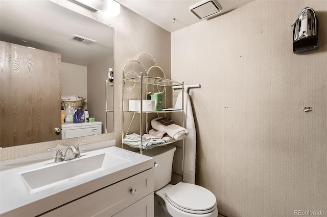 bathroom featuring vanity and toilet