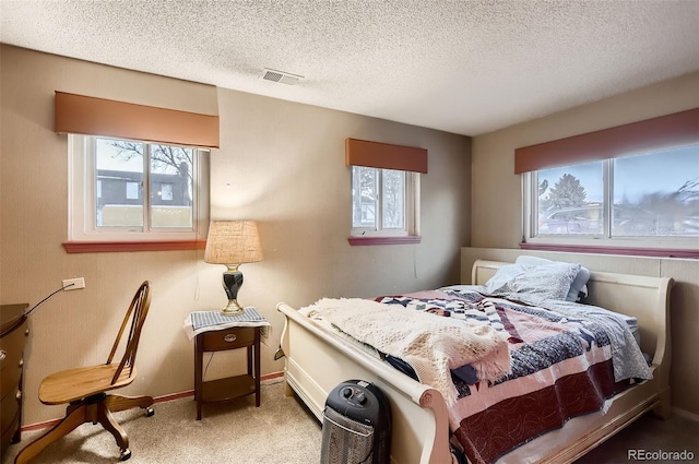 bedroom featuring carpet and a textured ceiling