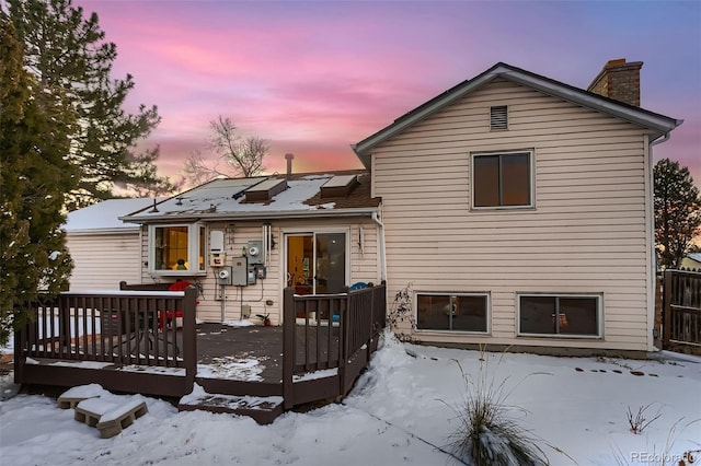 snow covered property featuring a wooden deck