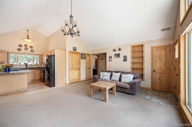 21 Crystal Rock Rd, Bailey, CO 80421 - living room featuring high vaulted ceiling, light carpet, and a chandelier