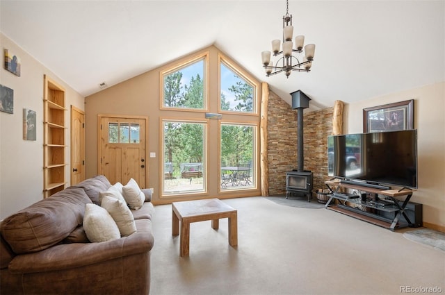 21 Crystal Rock Rd, Bailey, CO 80421 - carpeted living area with a chandelier, a wood stove, and high vaulted ceiling