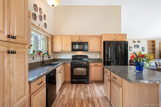 21 Crystal Rock Rd, Bailey, CO 80421 - kitchen with black appliances, light brown cabinetry, a towering ceiling, light wood-style floors, and dark stone countertops