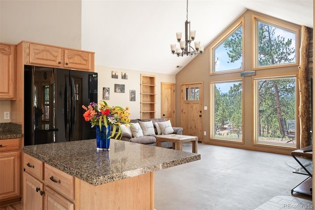 21 Crystal Rock Rd, Bailey, CO 80421 - kitchen with freestanding refrigerator, high vaulted ceiling, light brown cabinetry, a chandelier, and light carpet