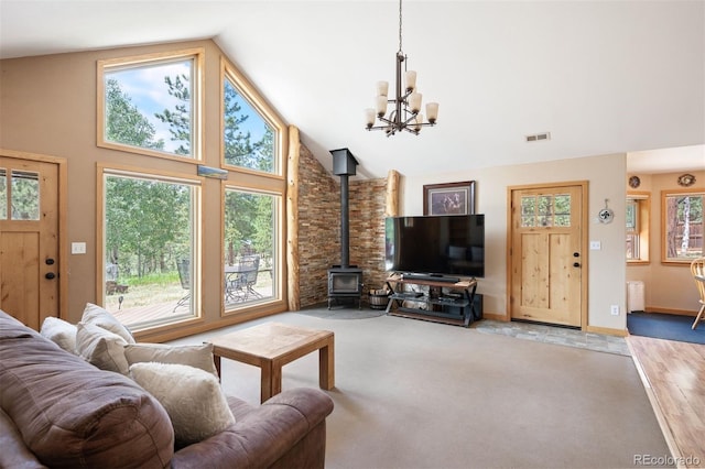 21 Crystal Rock Rd, Bailey, CO 80421 - living room with a wood stove, a chandelier, high vaulted ceiling, and carpet flooring