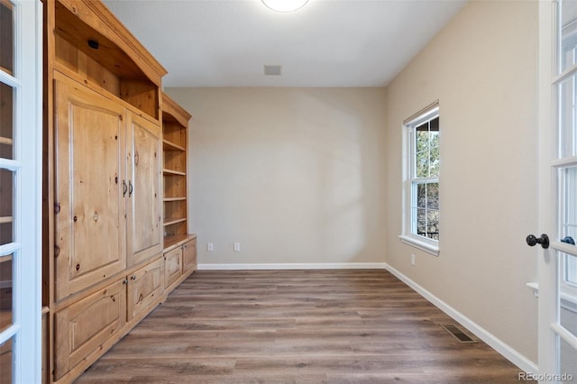 unfurnished room with dark hardwood / wood-style flooring