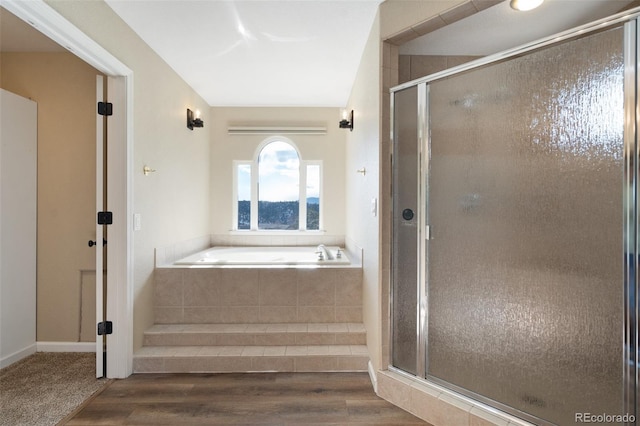 bathroom with separate shower and tub and hardwood / wood-style floors