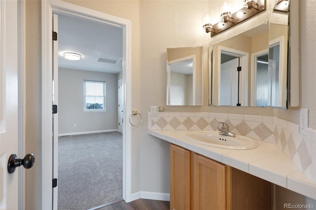 bathroom with vanity and decorative backsplash