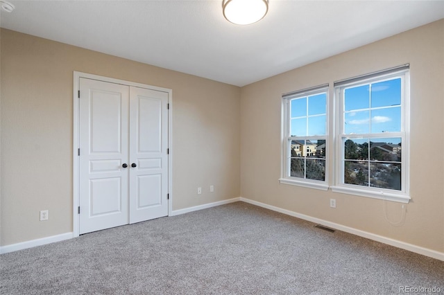 unfurnished bedroom featuring a closet and carpet flooring