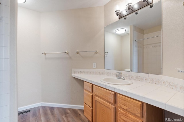 bathroom with vanity and hardwood / wood-style floors