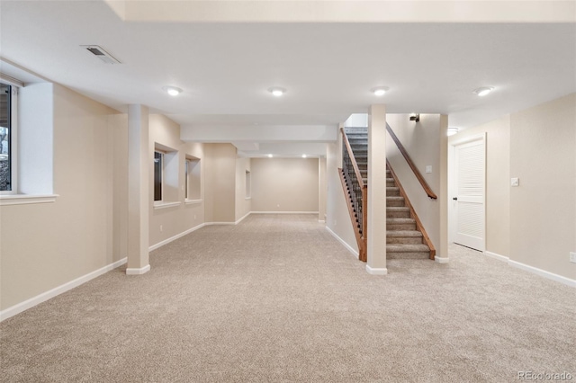 basement featuring light carpet