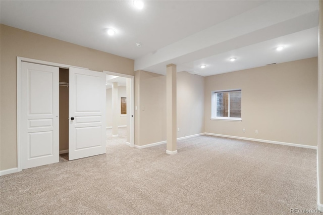 basement featuring light carpet