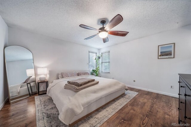 17372 E Prentice Cir, Centennial, CO 80015 - bedroom with dark wood-type flooring, a textured ceiling, a ceiling fan, and baseboards
