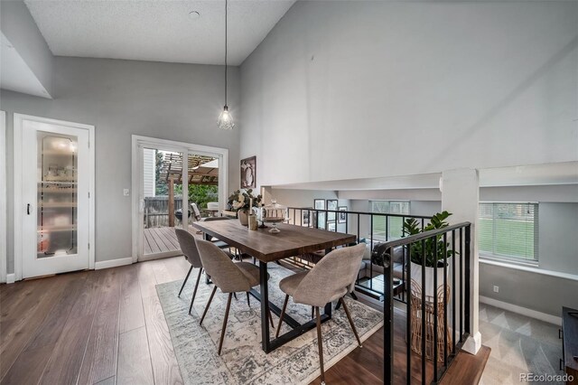 17372 E Prentice Cir, Centennial, CO 80015 - dining area with high vaulted ceiling, baseboards, plenty of natural light, and wood finished floors