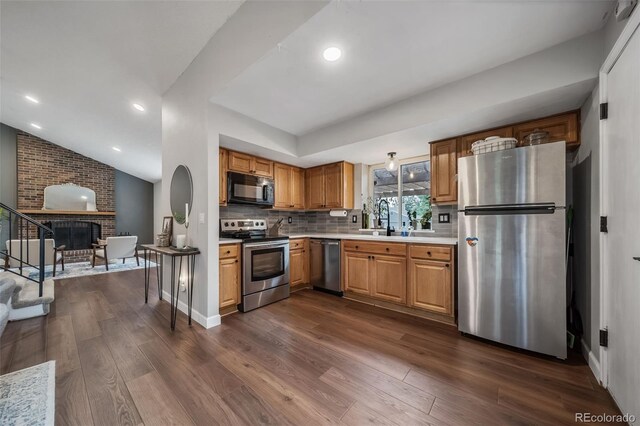 17372 E Prentice Cir, Centennial, CO 80015 - kitchen featuring stainless steel appliances, light countertops, dark wood-style flooring, a sink, and backsplash