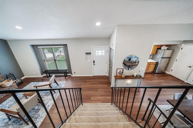 17372 E Prentice Cir, Centennial, CO 80015 - stairs with a textured ceiling, wood finished floors, baseboards, and recessed lighting