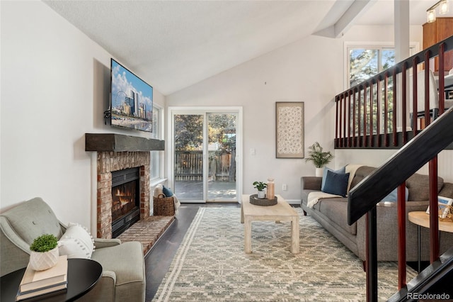 517 Chiswick Cir, Highlands Ranch, CO 80126 - living room featuring wood finished floors, a fireplace, stairs, and high vaulted ceiling