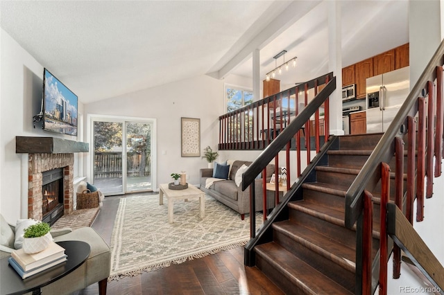 517 Chiswick Cir, Highlands Ranch, CO 80126 - living area featuring stairs, wood finished floors, healthy amount of natural light, a brick fireplace, and beam ceiling