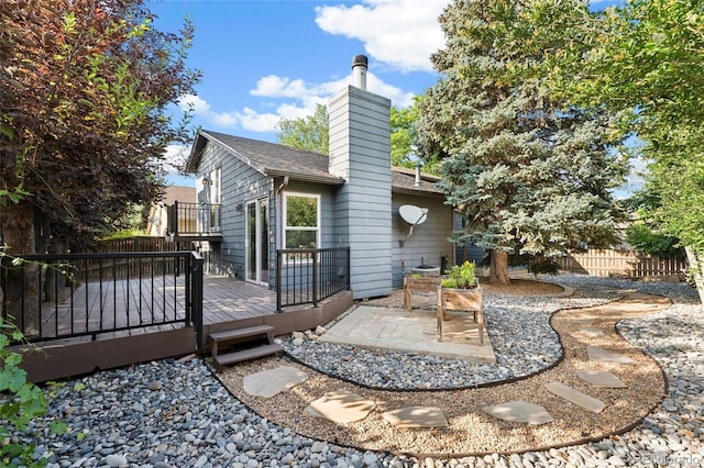 517 Chiswick Cir, Highlands Ranch, CO 80126 - back of house featuring a wooden deck, a chimney, and a patio