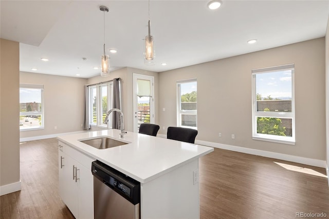 2374 S University Blvd Unit 202, Denver, CO 80210 - kitchen with stainless steel dishwasher, a sink, open floor plan, baseboards, and wood finished floors