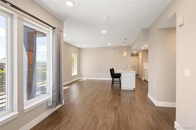 2374 S University Blvd Unit 202, Denver, CO 80210 - unfurnished living room featuring a sink, dark wood-style floors, baseboards, and recessed lighting
