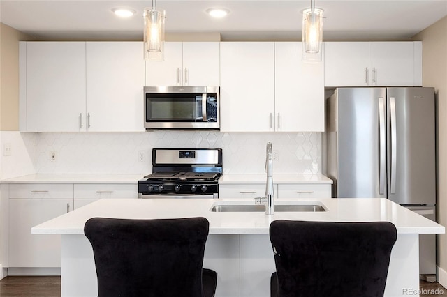 2374 S University Blvd Unit 202, Denver, CO 80210 - kitchen with appliances with stainless steel finishes, a sink, light countertops, pendant lighting, and white cabinets