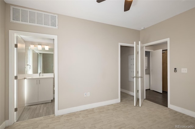 2374 S University Blvd Unit 202, Denver, CO 80210 - unfurnished bedroom featuring baseboards, light wood-style flooring, a sink, ensuite bathroom, and ceiling fan