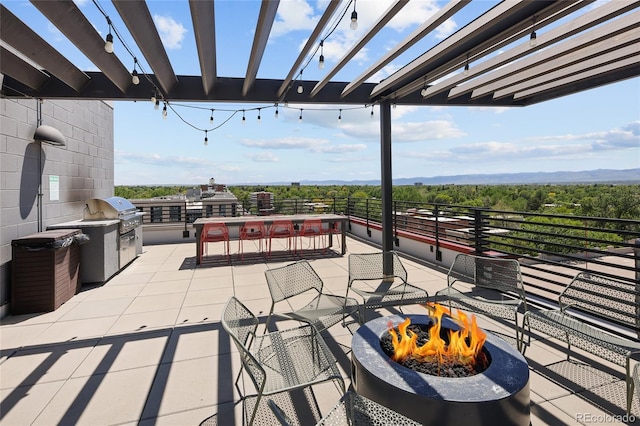 2374 S University Blvd Unit 202, Denver, CO 80210 - view of patio with an outdoor fire pit and a pergola