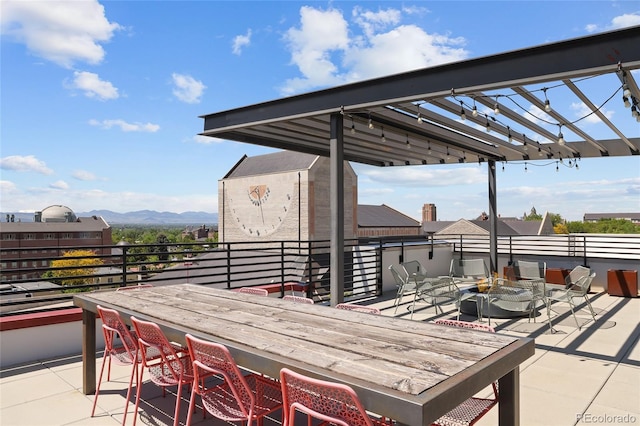 2374 S University Blvd Unit 202, Denver, CO 80210 - view of patio featuring a mountain view and an outdoor fire pit