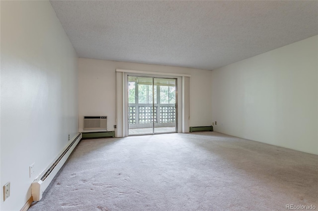 empty room with light carpet, a wall unit AC, a textured ceiling, and a baseboard radiator