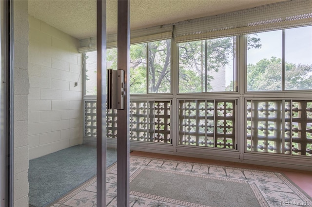 unfurnished sunroom with a healthy amount of sunlight